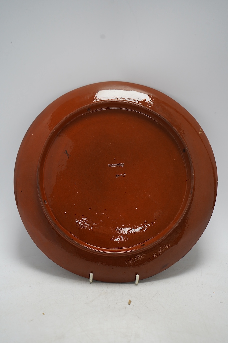 A late 19th century slipware Wedgwood wall plate, decorated with sunflowers, 25cm diameter. Condition - fair to good, some losses to the glaze on the rim